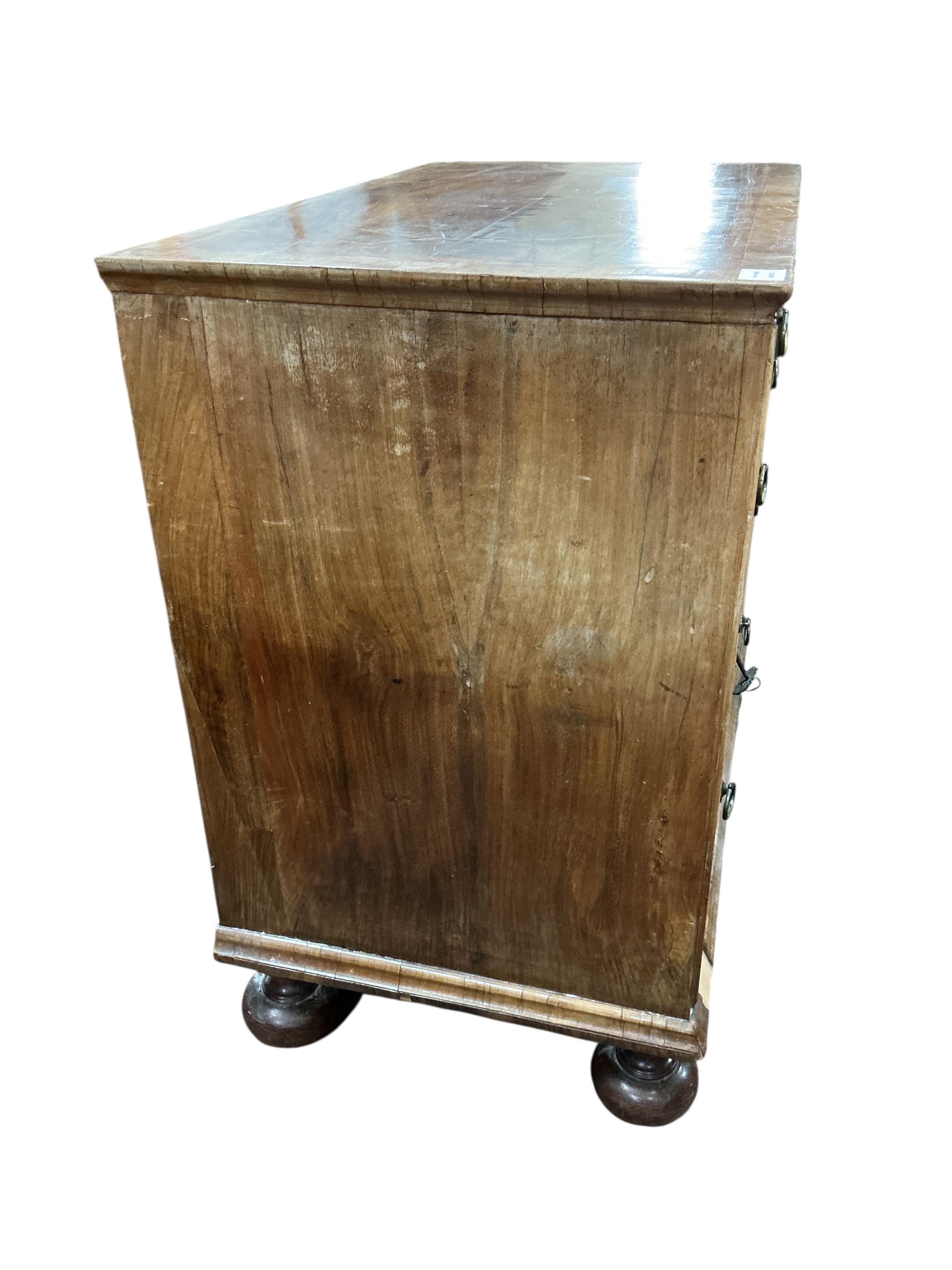 An early 18th century feather banded walnut chest, damaged, width 95cm, depth 54cm, height 91cm